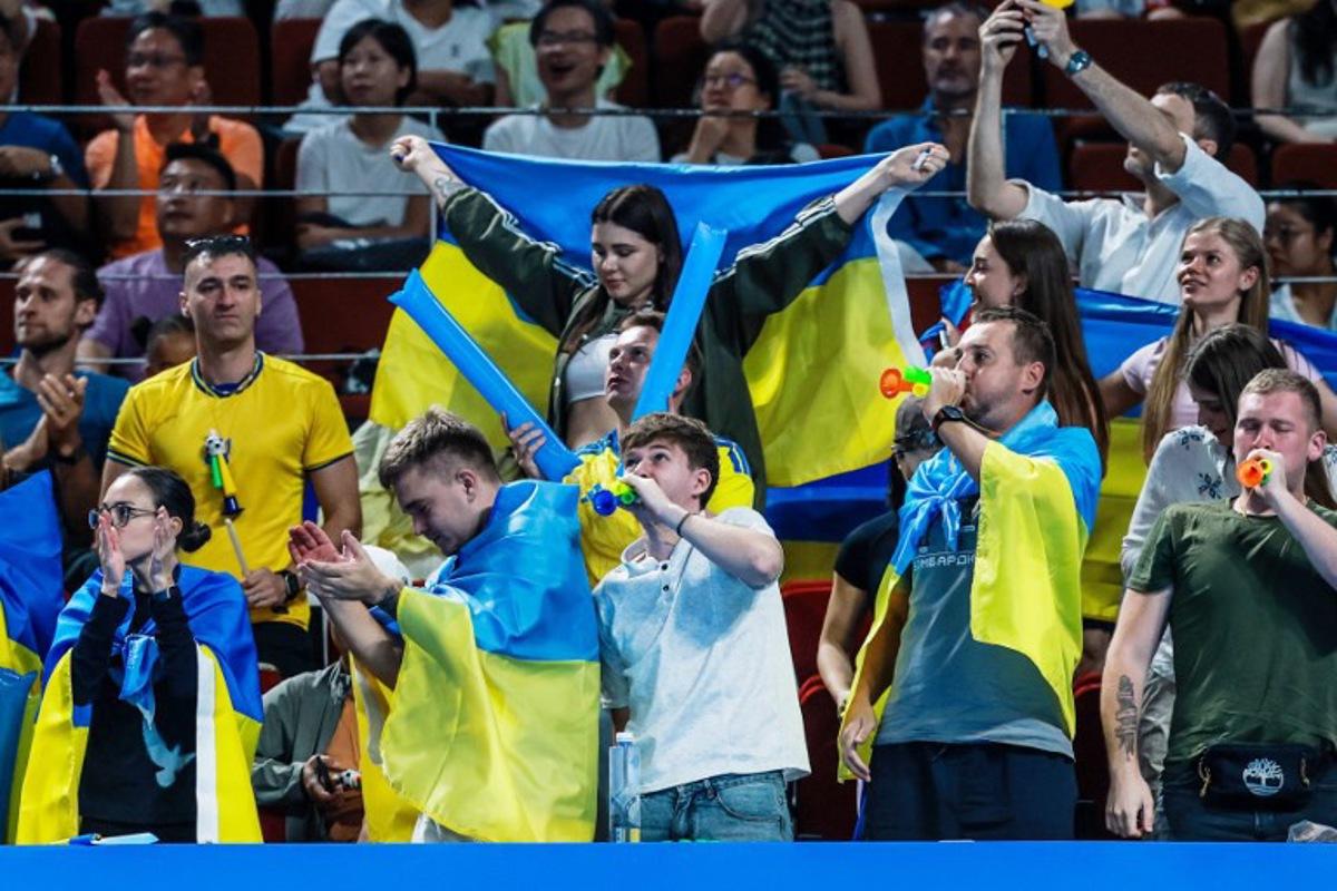 Ukraine's supporters cheer on Anhelina Kalinina during her women's singles semi-final match against Italy's Tyra Grant at the Billie Jean King Cup tennis tournament in Shenzhen, in China's southern Guangdong province on September 26, 2026. CN-STR / AFP