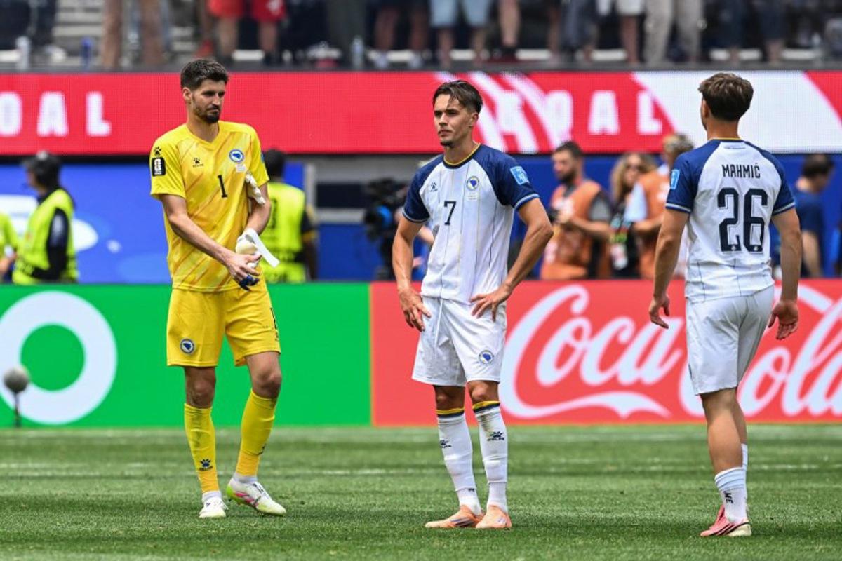 Bosnia-Herzegovina's goalkeeper #01 Nikola Vasilj, defender #07 Amar Dedic, and midfielder #26 Ermin Mahmic react after losing the 2026 World Cup Group B football match between Switzerland and Bosnia and Herzegovina at Los Angeles Stadium in Inglewood on June 18, 2026. Patrick T. Fallon / AFP