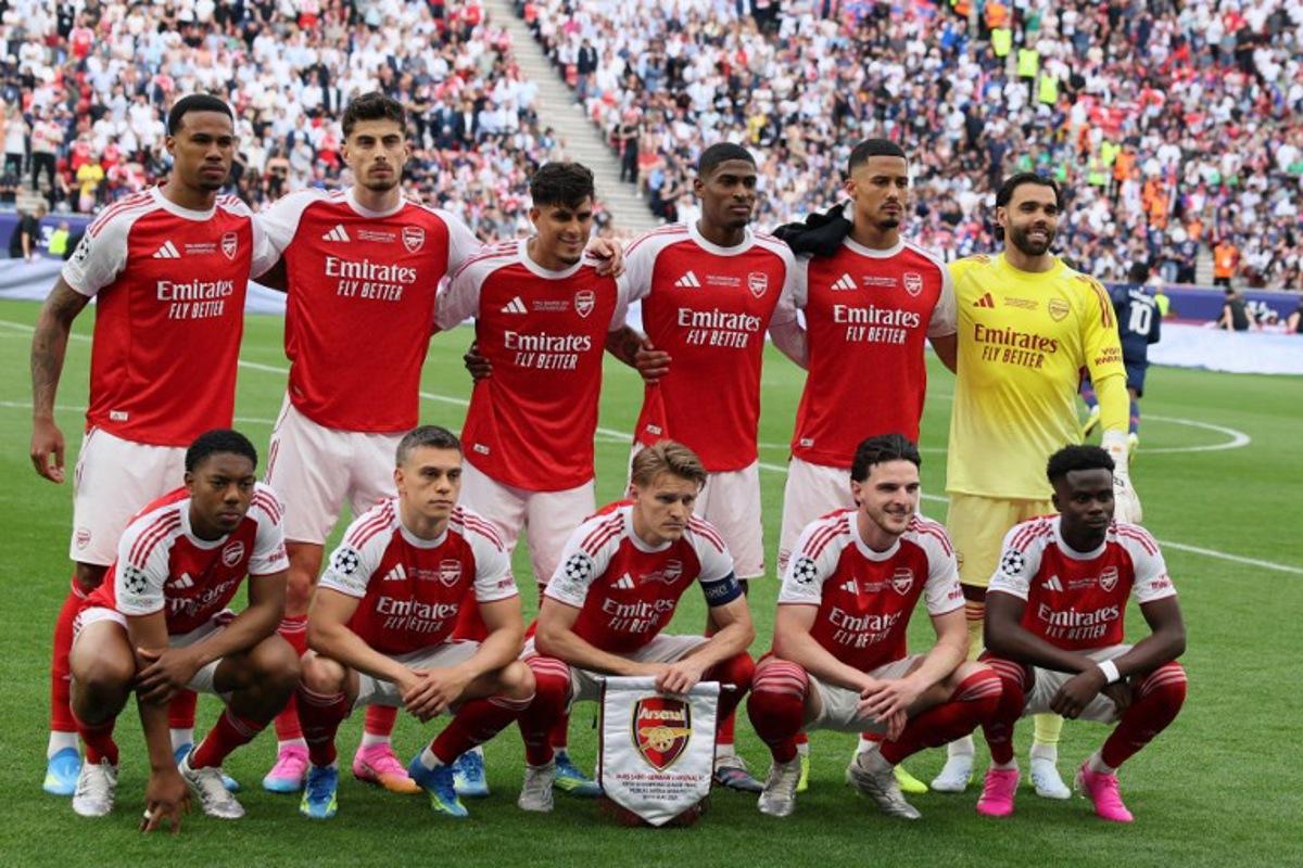 (back row from L to R) Arsenal's Brazilian defender #06 Gabriel Magalhaes, Arsenal's German midfielder #29 Kai Havertz, Arsenal's Ecuadorian defender #05 Piero Hincapie, Arsenal's Spanish defender #03 Cristhian Mosquera, Arsenal's French defender #02 William Saliba and Arsenal's Spanish goalkeeper #01 David Raya and (front row from L to R) Arsenal's English midfielder #49 Myles Lewis-Skelly, Arsenal's Belgian midfielder #19 Leandro Trossard, Arsenal's Norwegian midfielder #08 Martin Odegaard, Arsenal's English midfielder #41 Declan Rice and Arsenal's English midfielder #07 Bukayo Saka pose for a team photo before the UEFA Champions League final football match between Paris Saint-Germain (PSG) and Arsenal FC at the Puskas Arena in Budapest on May 30, 2026. Odd ANDERSEN / AFP