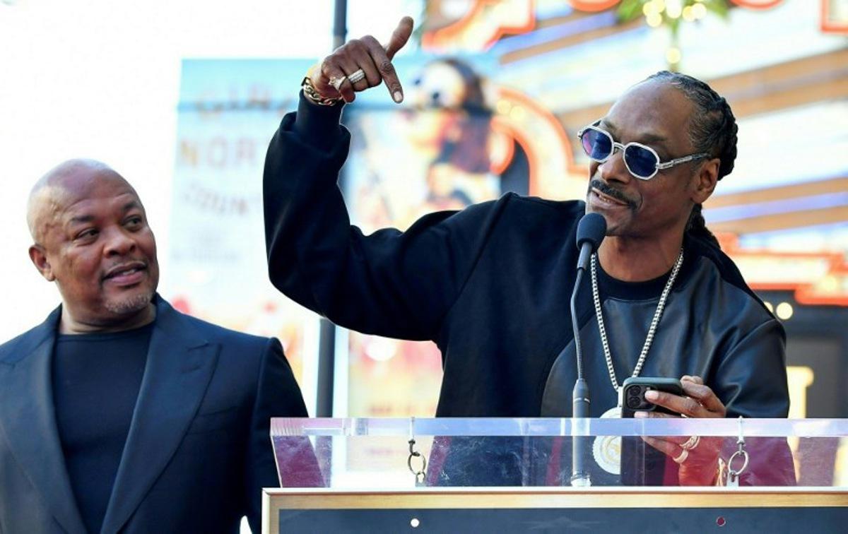 US rapper Dr. Dre (L) listens to US rapper Snoop Dog speak at his Hollywood Walk of Fame ceremony in Hollywood, California, on March 19, 2024. VALERIE MACON / AFP