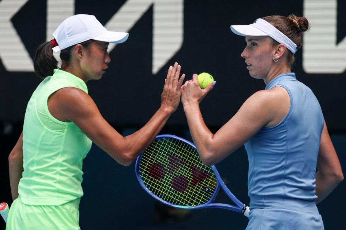 China's Zhang Shuai (L) gestures to partner Belgium's Elise Mertens during their women's doubles final match against Kazakhstan's Anna Danilina and Serbia's Aleksandra Krunic on day fourteen of the Australian Open tennis tournament in Melbourne on January 31, 2026. DAVID GRAY / AFP
