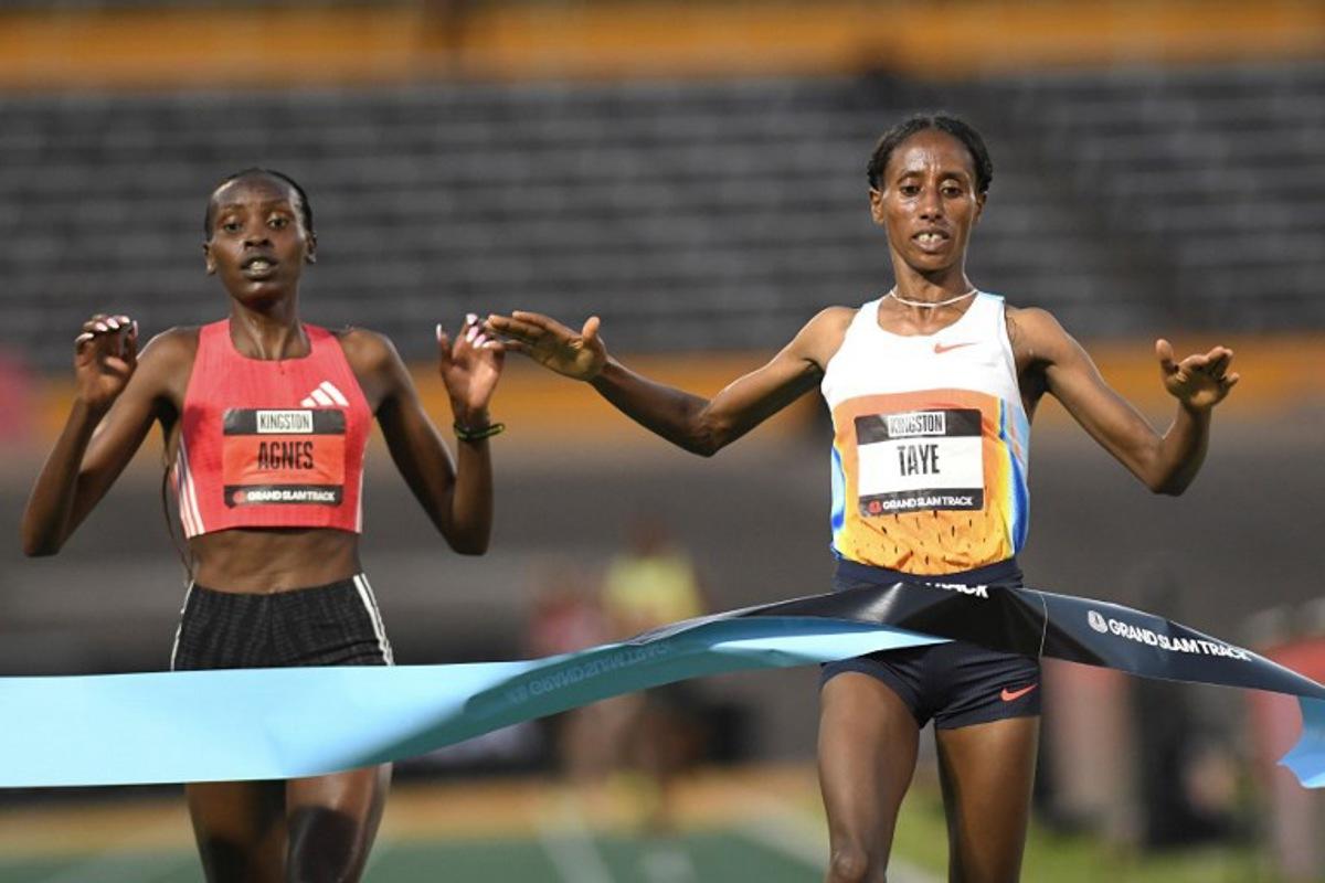 Ethiopia's Ejgayehu Taye (R) of team Nike crosses the finish line in first place ahead of Kenya's Agnes Jebet Ngetich of team Adidas in the the women's 3000 meters Long Distance during the Grand Slam Track competition at the National Stadium in Kingston, Jamaica on April 4, 2025. Ricardo Makyn / AFP