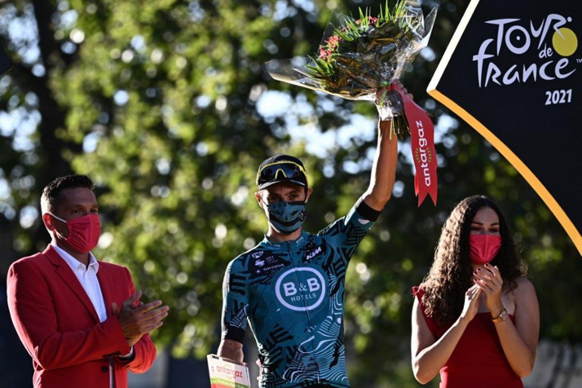 Team B&B KTM's Franck Bonnamour of France celebrates on the podium his super combative price at the end of the 21th and last stage of the 108th edition of the Tour de France cycling race, 108 km between Chatou and Paris Champs-Elysees, on July 18, 2021. Anne-Christine POUJOULAT / AFP