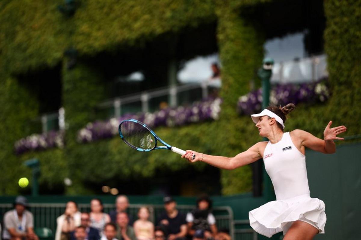 Romania's Irina-Camelia Begu returns the ball to Australia's Daria Kasatkina during their women's singles second round tennis match on the fourth day of the 2025 Wimbledon Championships at The All England Lawn Tennis and Croquet Club in Wimbledon, southwest London, on July 3, 2025. HENRY NICHOLLS / AFP