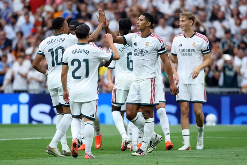 Real Madrid's English midfielder #05 Jude Bellingham celebrates with his teammates Real Madrid's French forward #10 Kylian Mbappe and Real Madrid's Moroccan forward #21 Brahim Diaz after scoring his team's second goal during the Spanish league football match between Real Madrid CF and Malaga CF at Santiago Bernabeu Stadium in Madrid on August 30, 2026. Thomas COEX / AFP