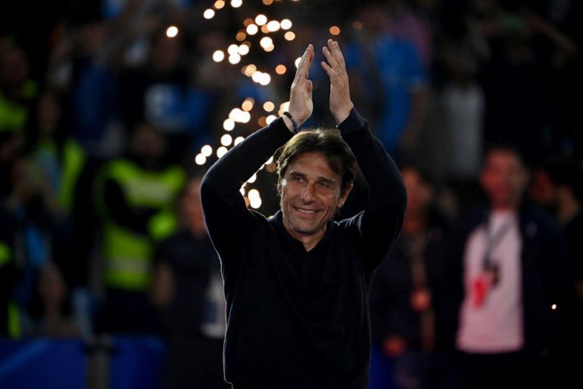 Napoli's Italian coach Antonio Conte applauds ahead of the trophy ceremony for the Italian Champions following the Italian Serie A football match between Napoli and Cagliari at the Diego Armando Maradona stadium in Naples on May 23, 2025. Isabella BONOTTO / AFP
