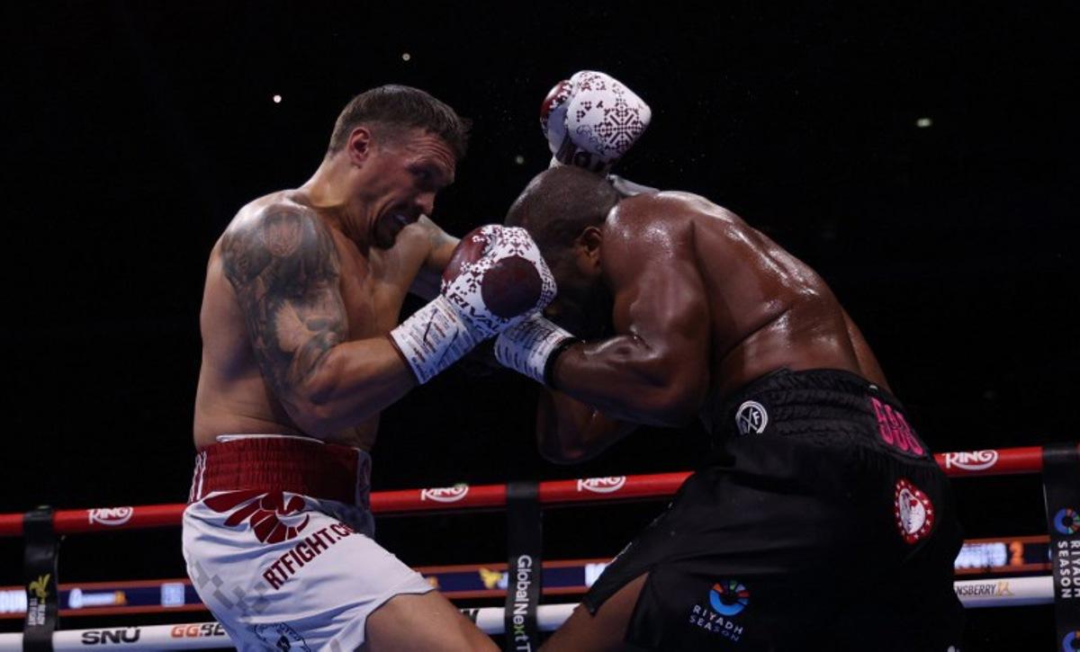 Ukraine's Oleksandr Usyk (L) and Britain's Daniel Dubois fight during their undisputed world heavyweight boxing title bout at Wembley Stadium in London on July 19, 2025. Adrian Dennis / AFP