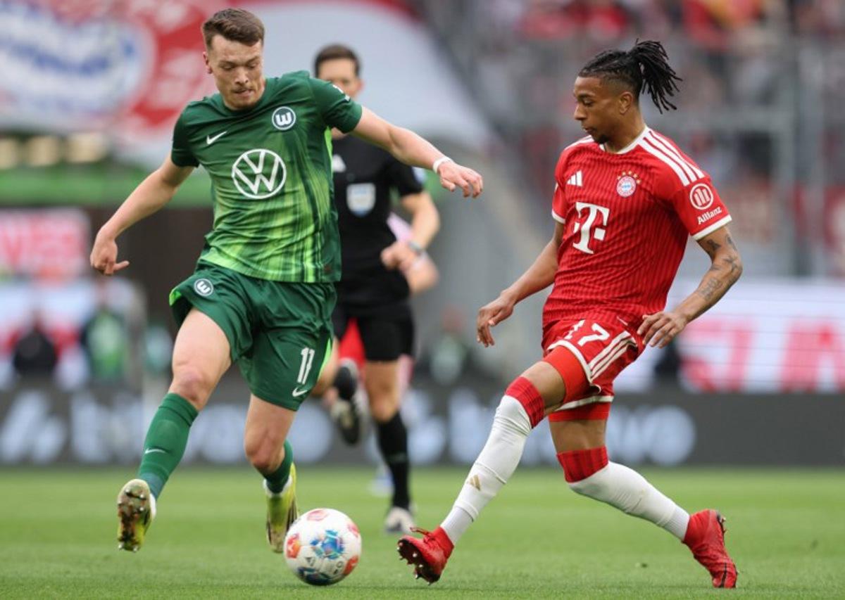 Bayern Munich's French midfielder #17 Michael Olise (R) and Wolfsburg's German forward #17 Dzenan Pejcinovic vie for the ball during the German first division Bundesliga football match between VfL Wolfsburg and FC Bayern Munich in Wolfsburg, on May 9, 2026. Ronny HARTMANN / AFP