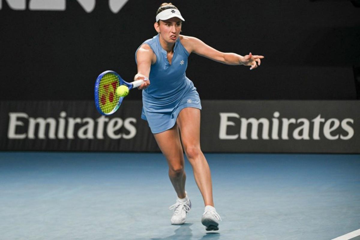 Belgium's Elise Mertens hits a return against Thailand's Lanlana Tararudee during their women's singles match on day two of the Australian Open tennis tournament in Melbourne on January 19, 2026. Paul Crock / AFP