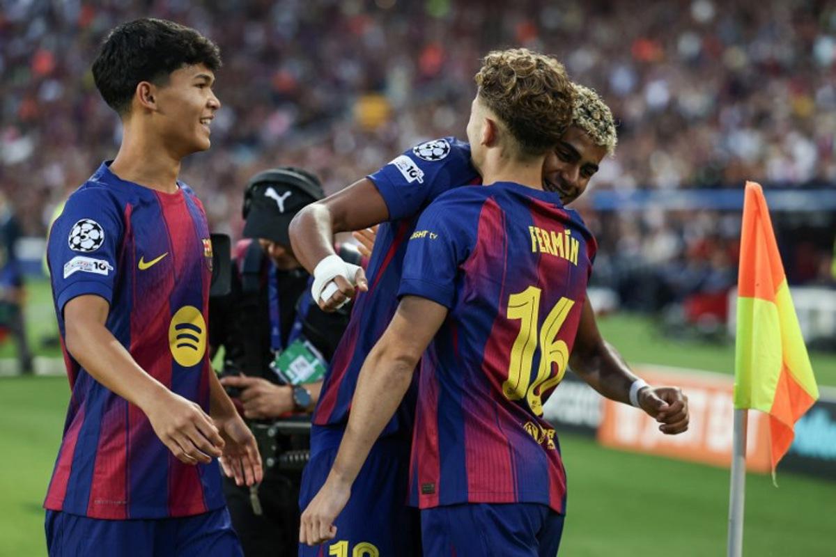 Barcelona's Spanish midfielder #16 Fermin Lopez (R) celebrates scoring their first goal with Barcelona's Spanish forward #10 Lamine Yamal and Barcelona's Spanish midfielder #27 Pedro Fernandez "Dro" (L) during the UEFA Champions League league phase match-day 3 football match between FC Barcelona and Olympiakos FC at Estadi Olimpic Lluis Companys in Barcelona on October 21, 2025. Josep LAGO / AFP