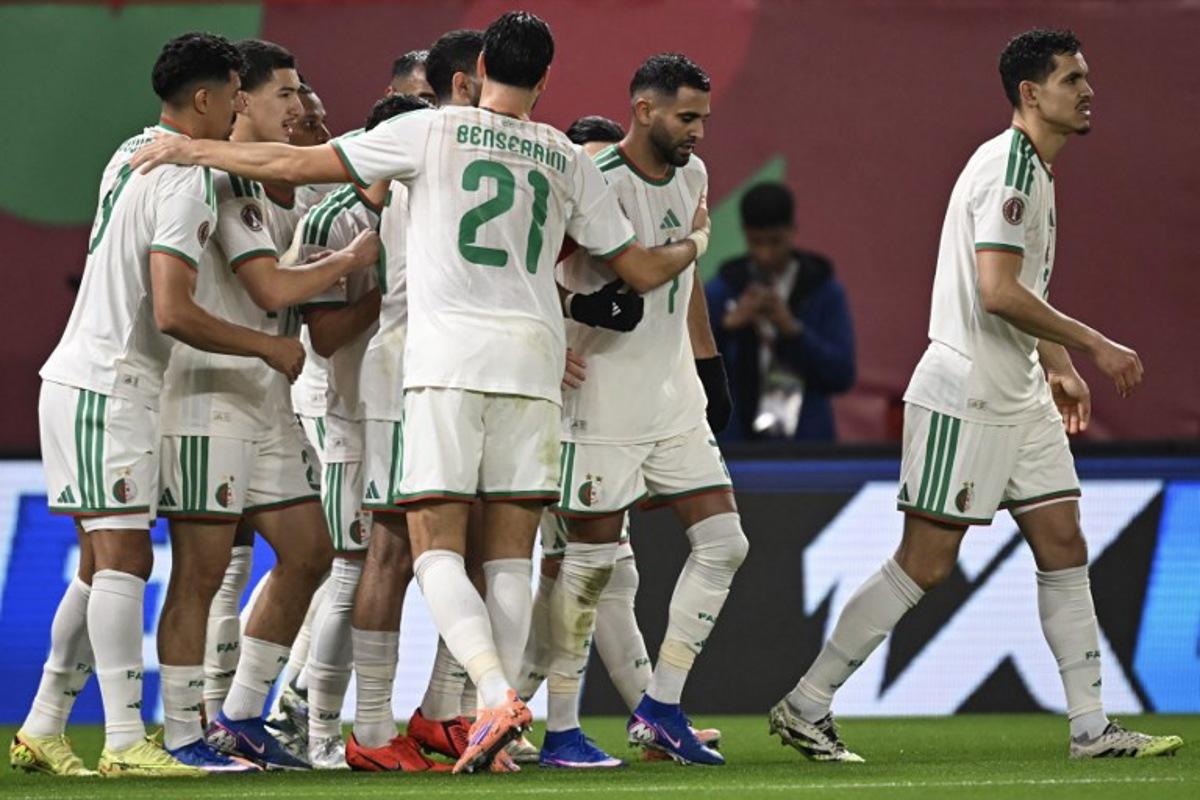 Algeria's forward #7 Riyad Mahrez (C) celebrates his team's first goal with his teammates during the Africa Cup of Nations (CAN) Group E football match between Algeria and Burkino Faso at Moulay Hassan Stadium in Rabat on December 28, 2025. Paul ELLIS / AFP