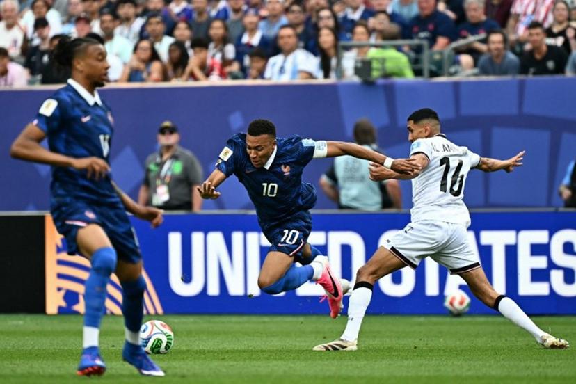 France's forward #10 Kylian Mbappe eludes Iraq's midfielder #16 Amir Al Ammari during the 2026 World Cup Group I football match between France and Iraq at the Philadelphia Stadium in Philadelphia on June 22, 2026. Jewel SAMAD / AFP