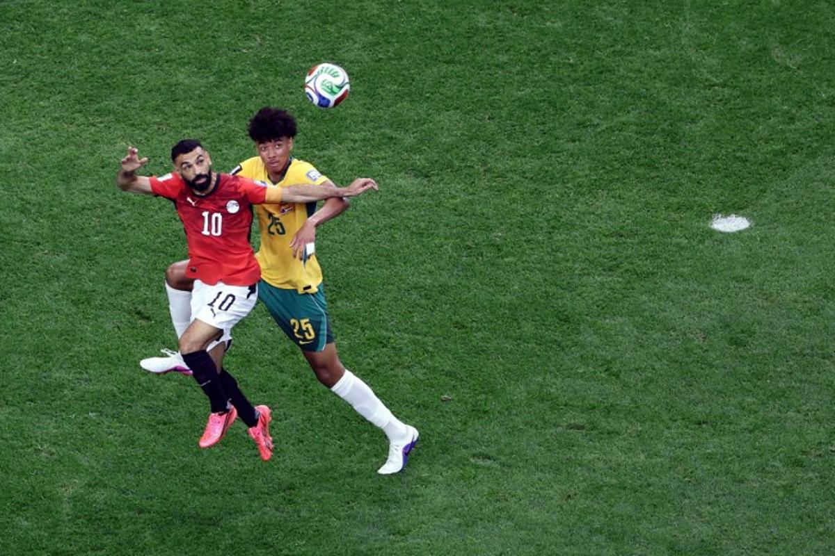 Australia's defender #25 Lucas Herrington (R) and Egypt's forward #10 Mohamed Salah jump for the ball during the 2026 World Cup round of 32 football match between Australia and Egypt at the Dallas Stadium in Arlington on July 3, 2026. Aric Becker / AFP