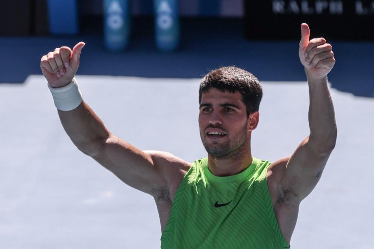 Spain's Carlos Alcaraz celebrates after winning against Germany's Yannick Hanfmann during their men's singles match on day four of the Australian Open tennis tournament in Melbourne on January 21, 2026. IZHAR KHAN / AFP