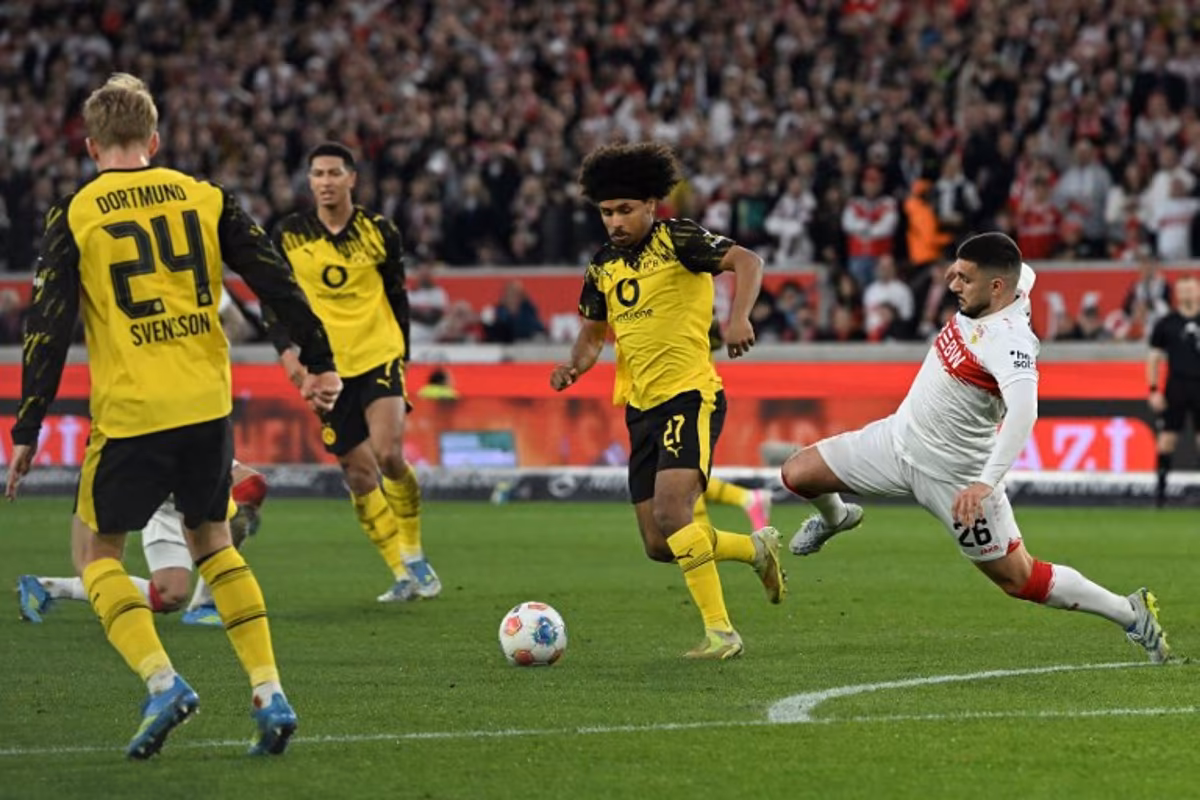Stuttgart's German forward #26 Deniz Undav (R) and Dortmund's German forward #27 Karim Adeyemi vie for the ball during the German first division Bundesliga football match between VfB Stuttgart and BVB Borussia Dortmund in Stuttgart, southern Germany, on April 4, 2026. THOMAS KIENZLE / AFP