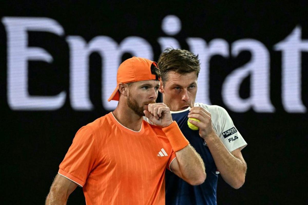 Great Britain's Neal Skupski (R) speaks with partner USA's Christian Harrison during their men's doubles final match against Australia's Jason Kubler and Marc Polmans on day fourteen of the Australian Open tennis tournament in Melbourne on January 31, 2026. WILLIAM WEST / AFP