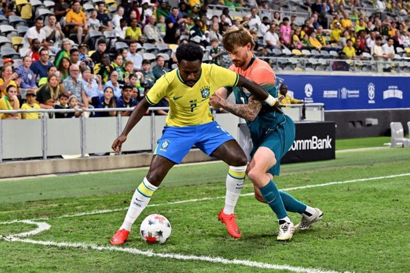 Brazil's Vinicius Junior (L) and Australia's Connor Metcalfe fight for the ball during the International friendly football match between Australia and Brazil at Queensland Country Bank Stadium in Townsville on September 25, 2026. SAEED KHAN / AFP