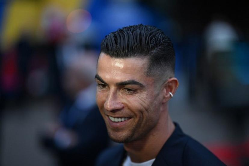 Portugal's forward #07 Cristiano Ronaldo speaks to journalists as he and his teammates arrive at their hotel at their base camp in Harsewinkel, on June 13, 2024, ahead of the UEFA Euro 2024 football championship. PATRICIA DE MELO MOREIRA / AFP