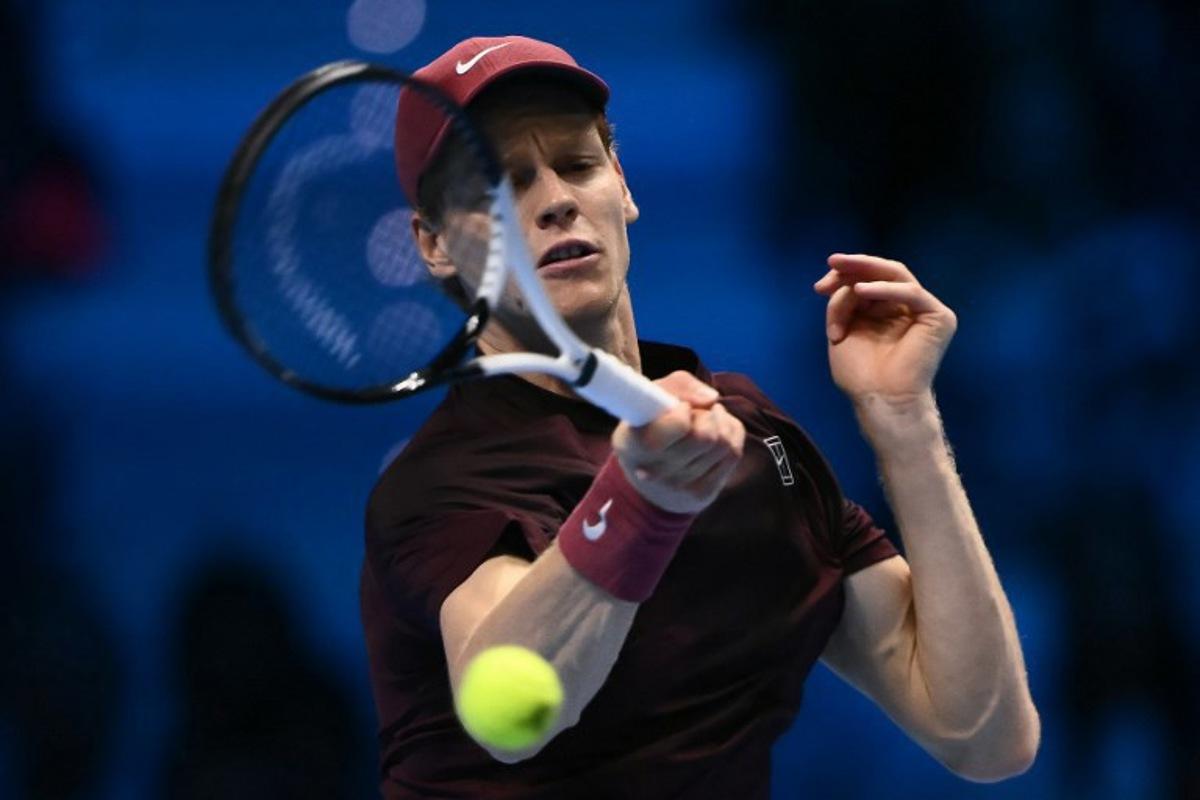 Italy's Jannik Sinner hits a return against USA's Ben Shelton during their match at the ATP Finals tennis tournament in Turin on November 14, 2025. Marco BERTORELLO / AFP