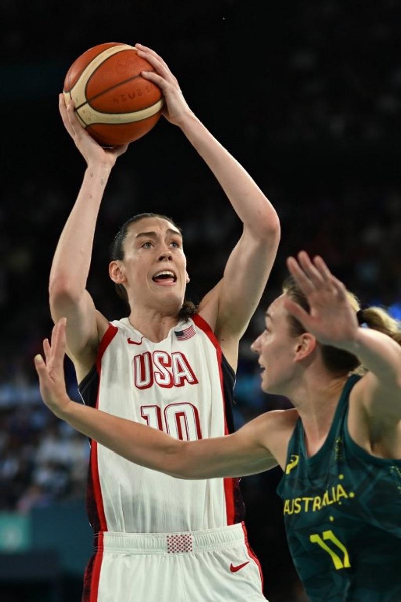 USA's #10 Breanna Stewart takes a shot over Australia's #11 Alanna Smith in the women's semifinal basketball match between USA and Australia during the Paris 2024 Olympic Games at the Bercy Arena in Paris on August 9, 2024. Paul ELLIS / AFP