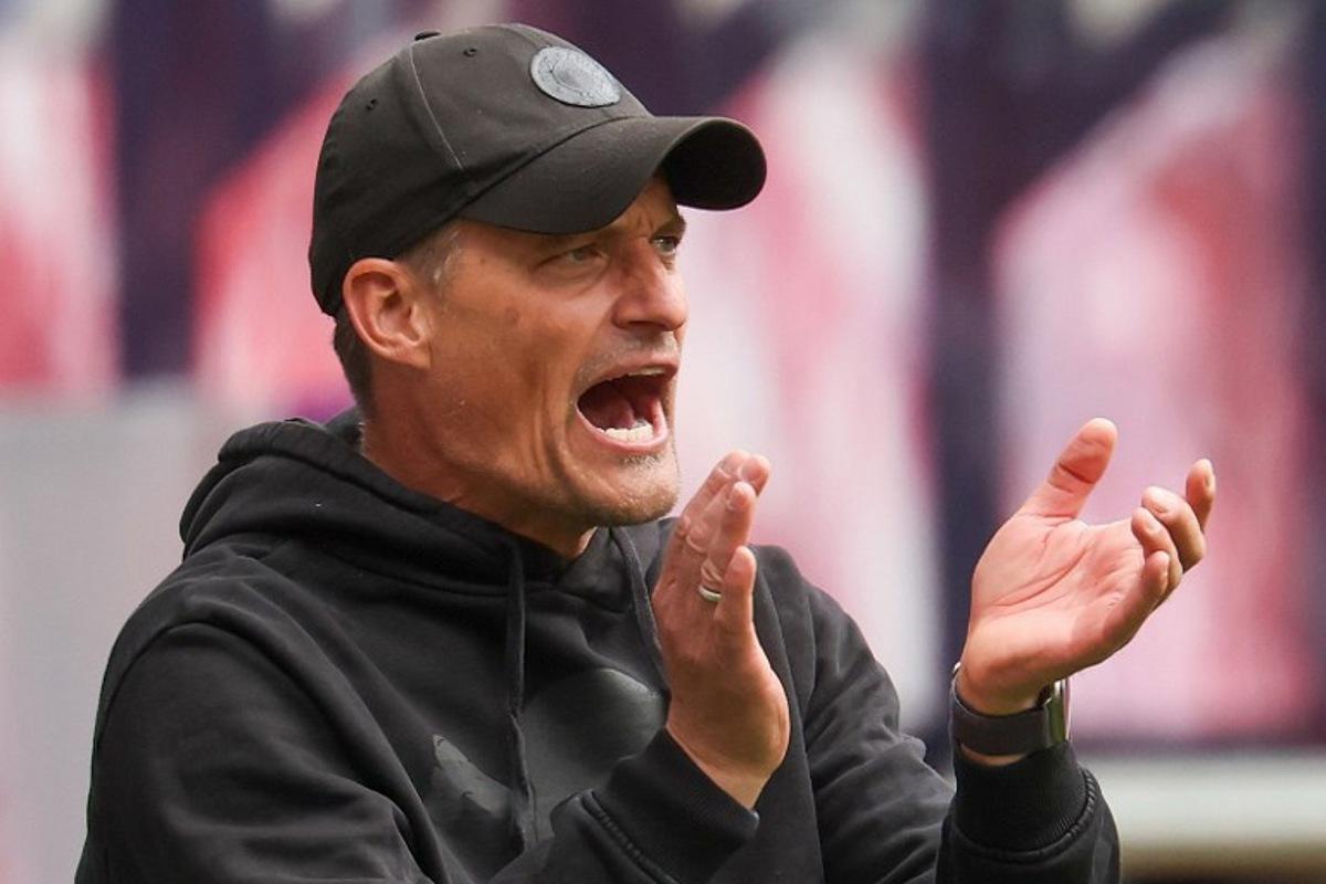 St Pauli's German head coach Alexander Blessin applauds his players from the sidelines during the German first division Bundesliga football match between RB Leipzig and St Pauli in Leipzig, eastern Germany, on May 9, 2026. Odd ANDERSEN / AFP