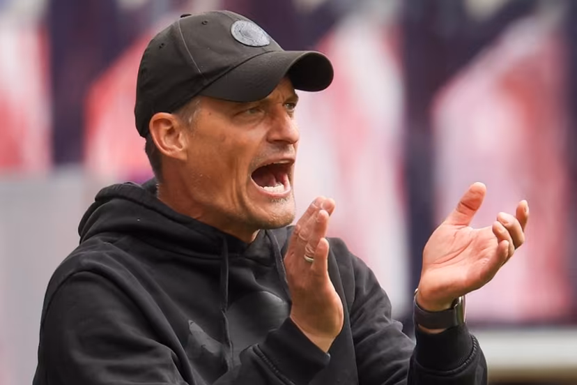 St Pauli's German head coach Alexander Blessin applauds his players from the sidelines during the German first division Bundesliga football match between RB Leipzig and St Pauli in Leipzig, eastern Germany, on May 9, 2026. Odd ANDERSEN / AFP