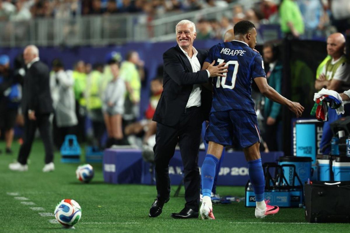 France's forward #10 Kylian Mbappe hugs head coach Didier Deschamps after being substituted during the 2026 World Cup Group I football match between France and Iraq at the Philadelphia Stadium in Philadelphia on June 22, 2026. FRANCK FIFE / AFP