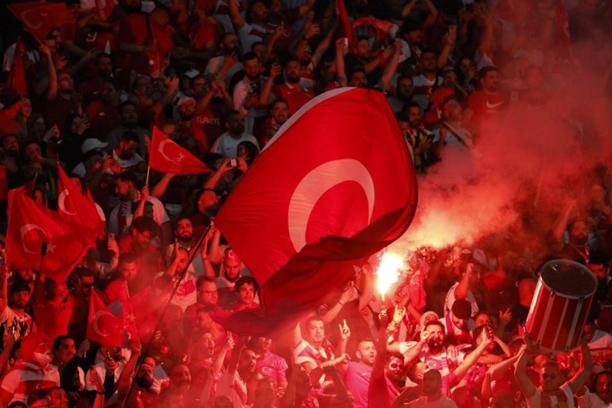 Turkey fans light flares and some make the controversial hand gesture associated with Turkish right-wing extremist group Grey Wolves during the UEFA Euro 2024 quarter-final football match between the Netherlands and Turkey at the Olympiastadion in Berlin on July 6, 2024. Odd ANDERSEN / AFP