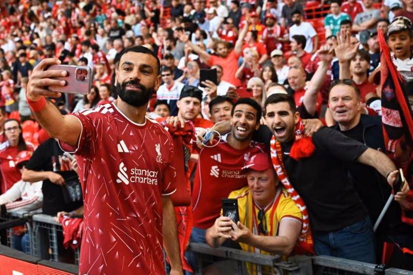Liverpool's Egyptian striker #11 Mohamed Salah takes a selfie with fans after the English Premier League football match between Liverpool and Brentford at Anfield in Liverpool, north west England on May 24, 2026. Paul ELLIS / AFP
