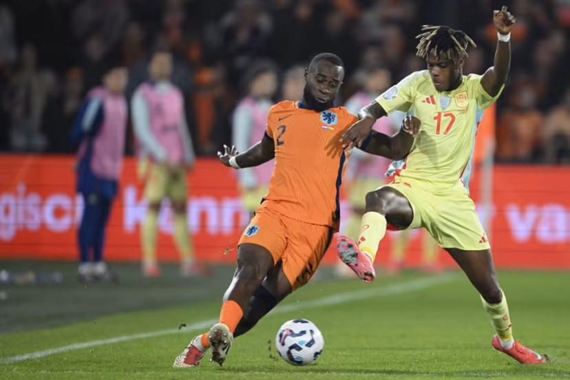 Netherlands' defender #02 Lutsharel Geertruida (L) fights for the ball with Spain's forward #17 Nico Williams (R) during the UEFA Nations League quarter-final first leg match between Netherlands and Spain at De Kuip stadium in Rotterdam, on March 20, 2025. NICOLAS TUCAT / AFP