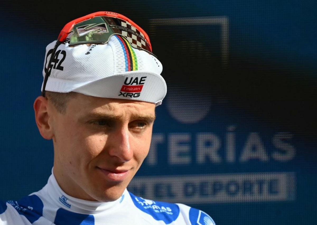 Team UAE's Slovenian rider Tadej Pogacar wearing the best climber's dotted jersey celebrates on the podium of the sixth stage of the Vuelta a Espana 2026, a 177,4 km race between Alcossebre and Castellon de la Plana on August 27, 2026. JOSE JORDAN / AFP