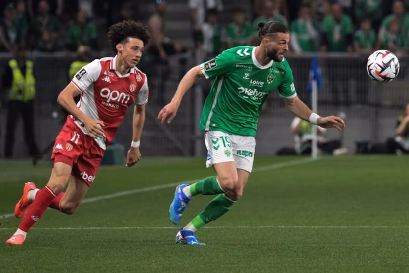Monaco's French midfielder #11 Maghnes Akliouche (L) fights the ball with Saint Etienne's French defender #19 Leo Petrot (R) during the French L1 football match between AS Saint-Etienne and AS Monaco at the Geoffroy Guichard Stadium in Saint-Etienne, central-eastern France, on May 3, 2025. JEAN-PHILIPPE KSIAZEK / AFP