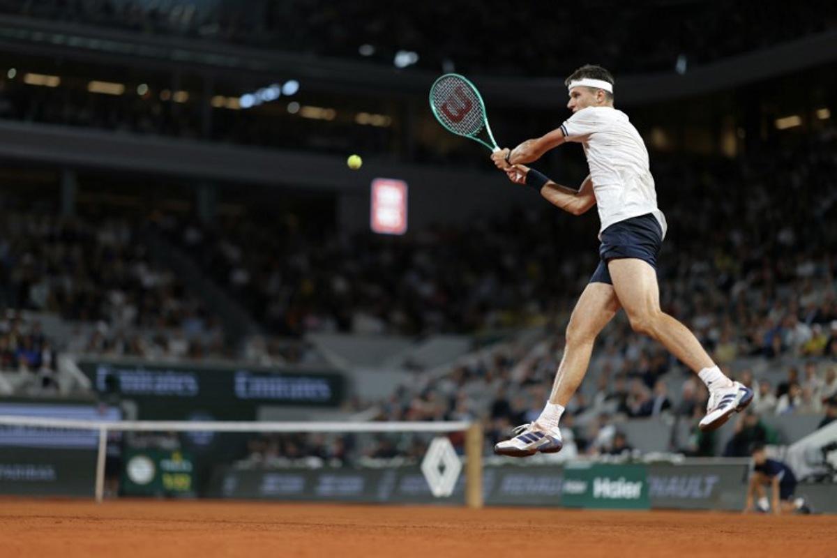 Czech Republic's Jakub Mensik plays a backhand return to Brazil's Joao Fonseca during their men's quarter final singles match on day 10 of the French Open tennis tournament on Court Philippe-Chatrier at the Roland-Garros Complex in Paris on June 2, 2026. Thomas SAMSON / AFP