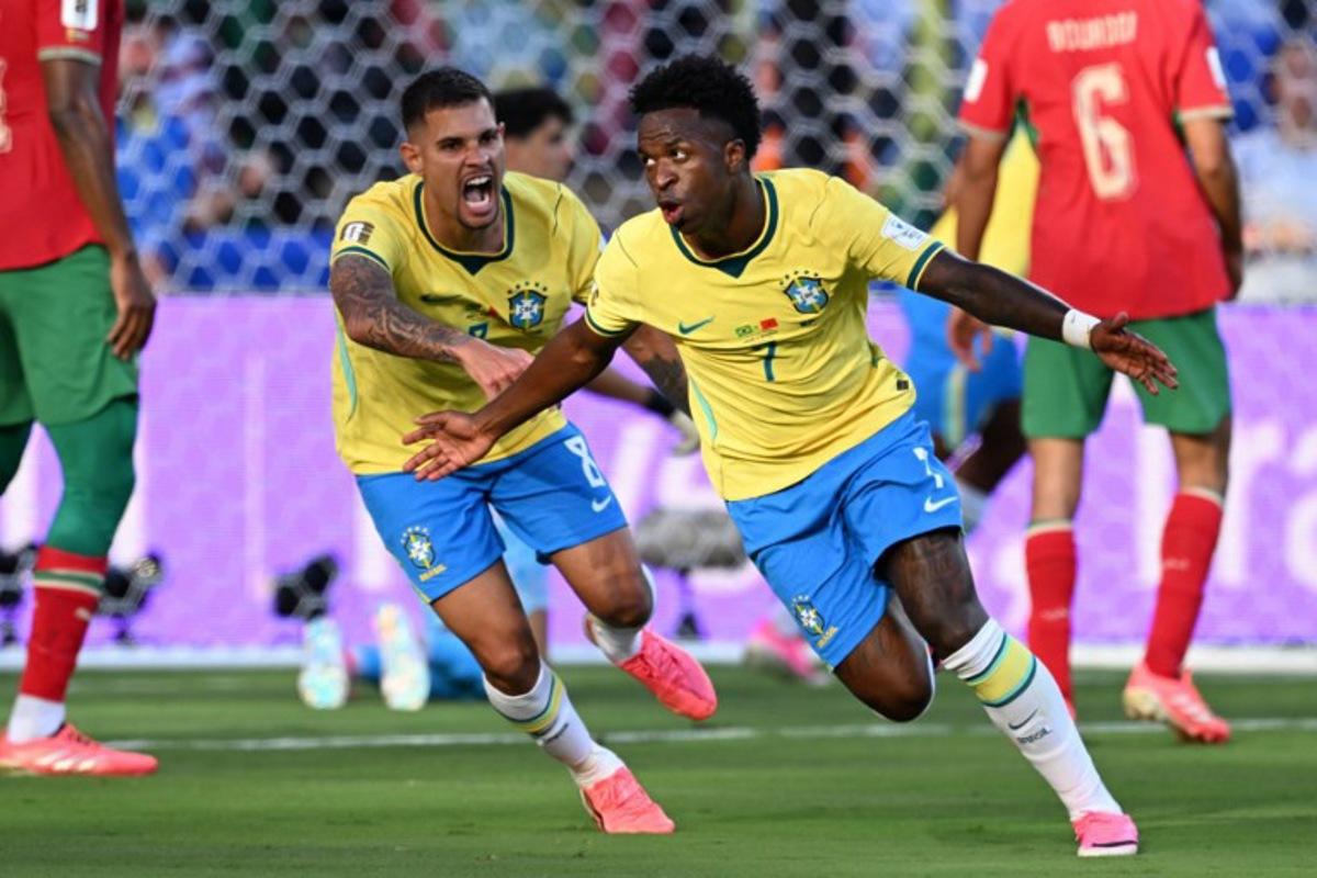 Brazil's forward #07 Vinicius Junior (R) celebrates scoring his team's first goal during the 2026 World Cup Group C football match between Brazil and Morocco at the New York/New Jersey Stadium in East Rutherford on June 13, 2026. Jewel SAMAD / AFP
