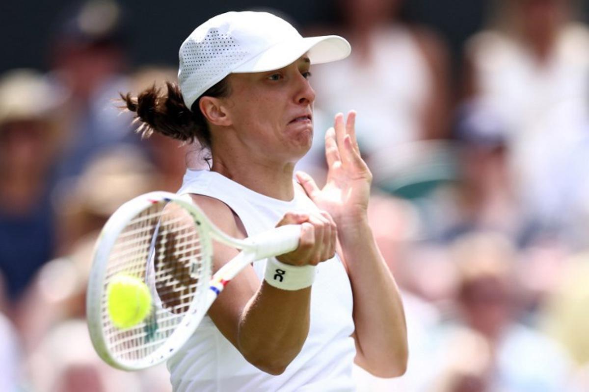 Poland's Iga Swiatek returns the ball to US player Taylor Townsend during their women's singles first round tennis match on the second day of the 2026 Wimbledon Championships at The All England Lawn Tennis and Croquet Club in Wimbledon, southwest London, on June 30, 2026. Henry Nicholls / AFP