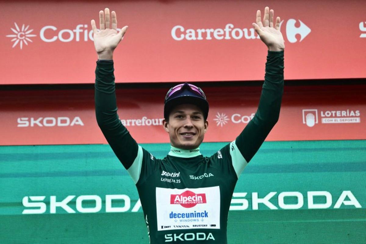 Team Alpecin's Belgian rider Jasper Philipsen, wearing the best sprinter's green jersey, poses on the podium after winning the second stage of the Vuelta a Espana, a 159,6 km race between Alba and Limone Piemonte, in Italy's Piemonte region, on August 24, 2025. Marco BERTORELLO / AFP