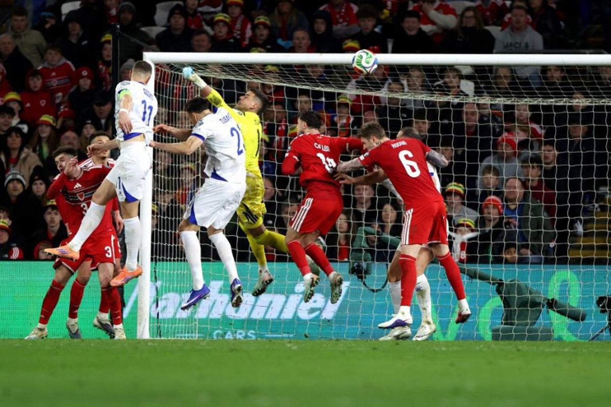Bosnia-Herzegovina's forward Edin Dzeko scores the team's first goal during the FIFA World Cup qualification semi-final football match between Wales and Bosnia and Herzegovina, at Cardiff City Stadium, in Cardiff, on March 26, 2026. Darren Staples / AFP