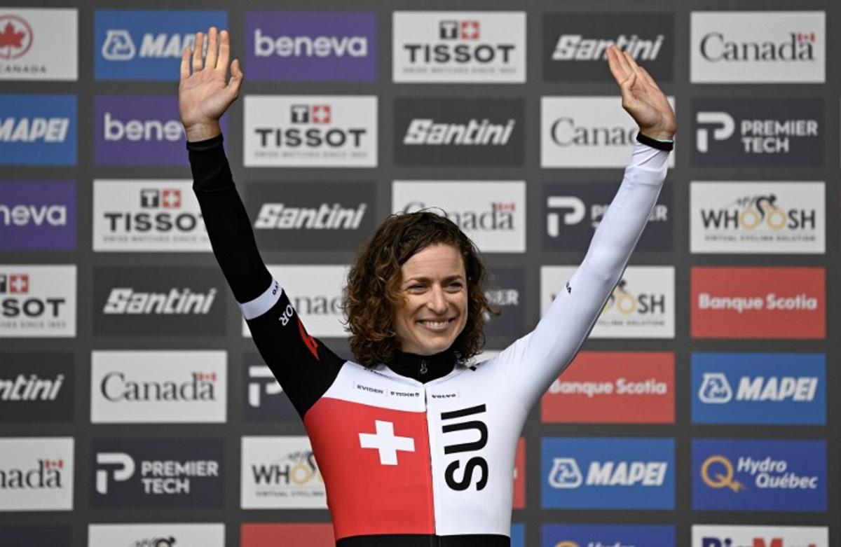Switzerland's Marlen Reusser celebrates on the podium after finishing in first place in the Women Elite Individual Time Trial during the 2026 Union Cycliste Internationale (UCI) Road World Championships in Montreal, Quebec, on September 20, 2026. Andrej Ivanov / AFP