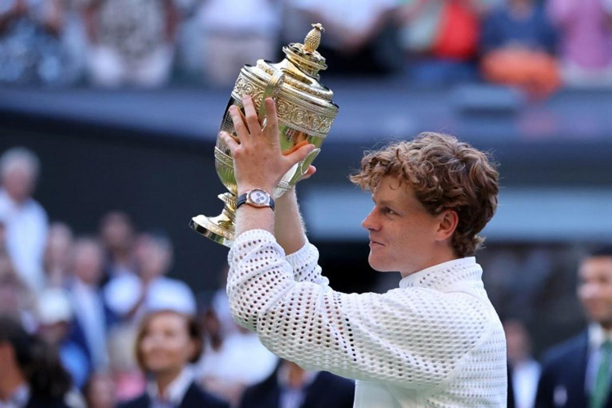 Italy's Jannik Sinner poses with the Gentleman's Singles trophy after his victory against Germany's Alexander Zverev at the end of their men's singles final tennis match on the last day of the 2026 Wimbledon Championships at The All England Lawn Tennis and Croquet Club in Wimbledon, southwest London, on July 12, 2026. Henry NICHOLLS / AFP