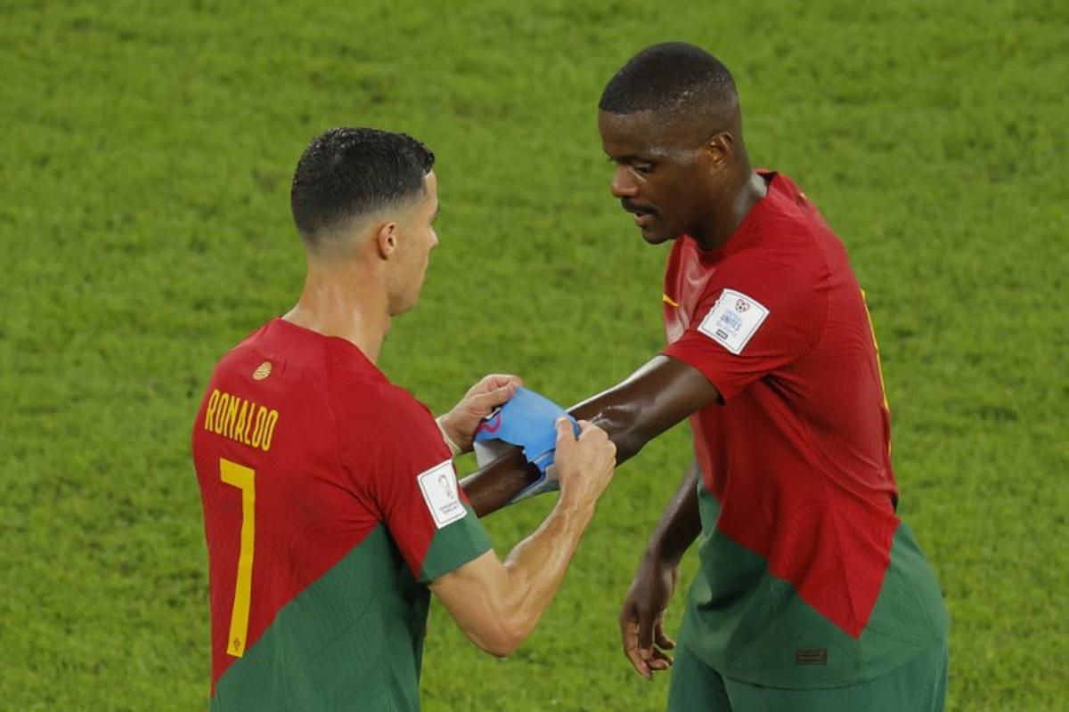 Portugal's forward #07 Cristiano Ronaldo gives the captain's armband to Portugal's midfielder #14 William Carvalho as he is replaced during the Qatar 2022 World Cup Group H football match between Portugal and Ghana at Stadium 974 in Doha on November 24, 2022. Odd ANDERSEN / AFP