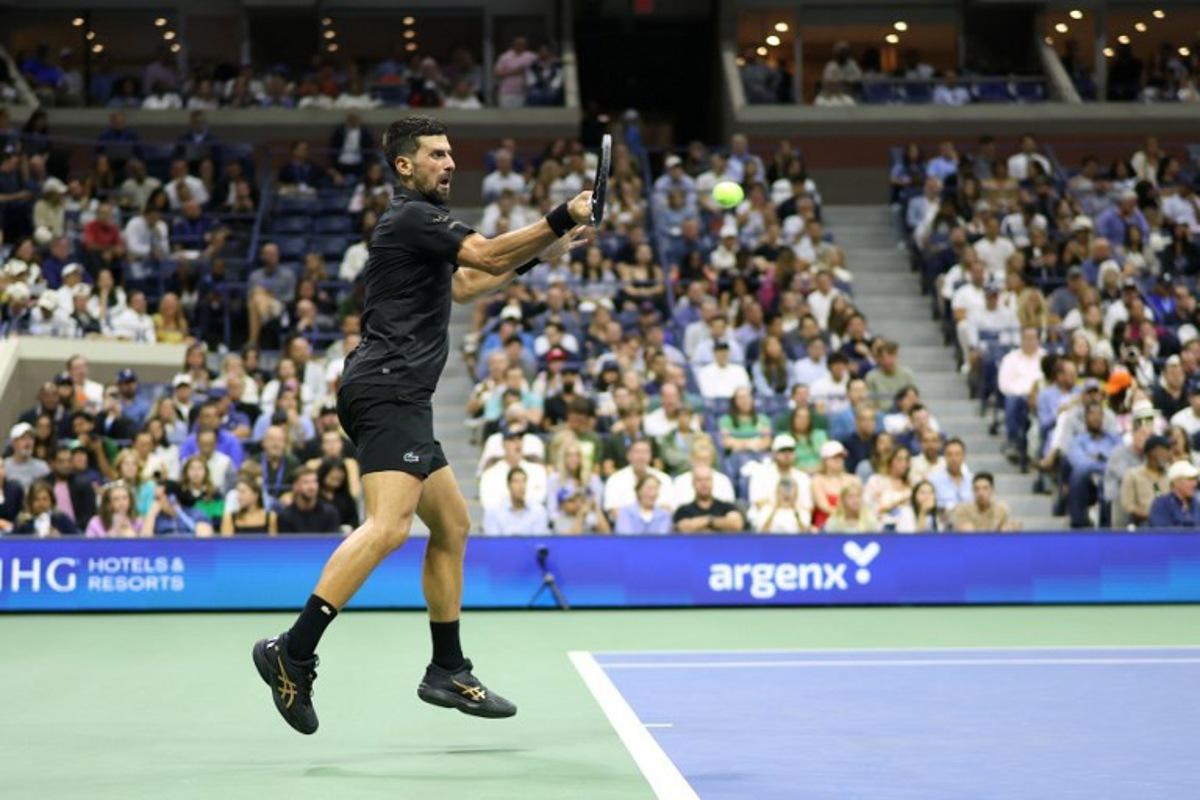 Serbia's Novak Djokovic hits a forehand return to Britain's Cameron Norrie during their men's singles third round match on day six of the US Open tennis tournament at the USTA Billie Jean King National Tennis Center in New York City on August 29, 2025. CHARLY TRIBALLEAU / AFP