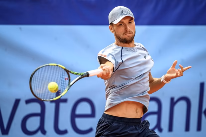 Belgium's Raphael Collignon returns the ball to Greece's Stefanos Tsitsipas during their men's singles final match at the Swiss Open tennis tournament in Gstaad, on July 19, 2026. Fabrice COFFRINI / AFP
