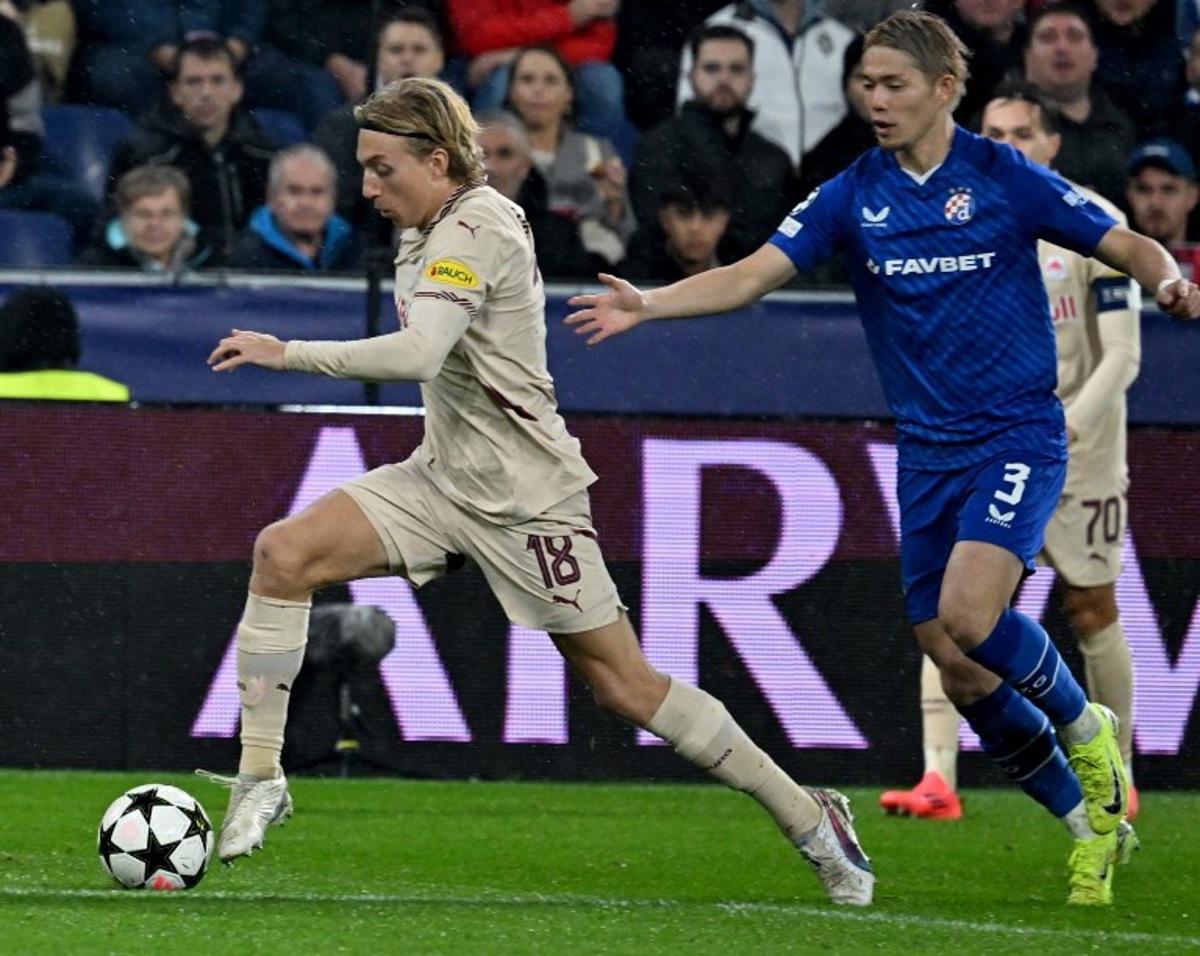 Salzburg's Danish midfielder #18 Mads Bidstrup (L) and Dinamo Zagreb's Japanese defender #03 Takuya Ogiwara vie for the ball during the UEFA Champions League football match between Salzburg and GNK Dinamo Zagreb in Salzburg, Austria on October 23, 2024. BARBARA GINDL / APA / AFP