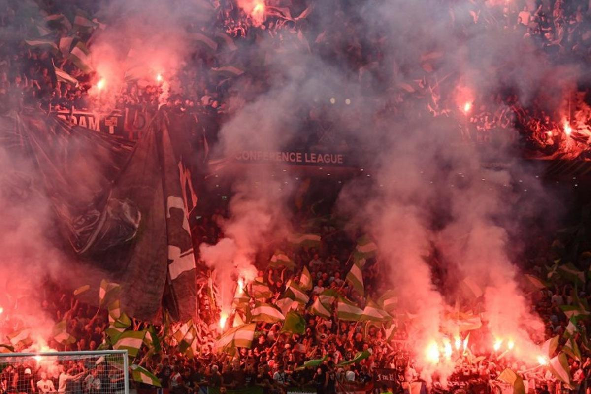 Feyenoord fans light flares during the UEFA Europa Conference League final football match between AS Roma and Feyenoord at the Air Albania Stadium in Tirana on May 25, 2022. OZAN KOSE / AFP