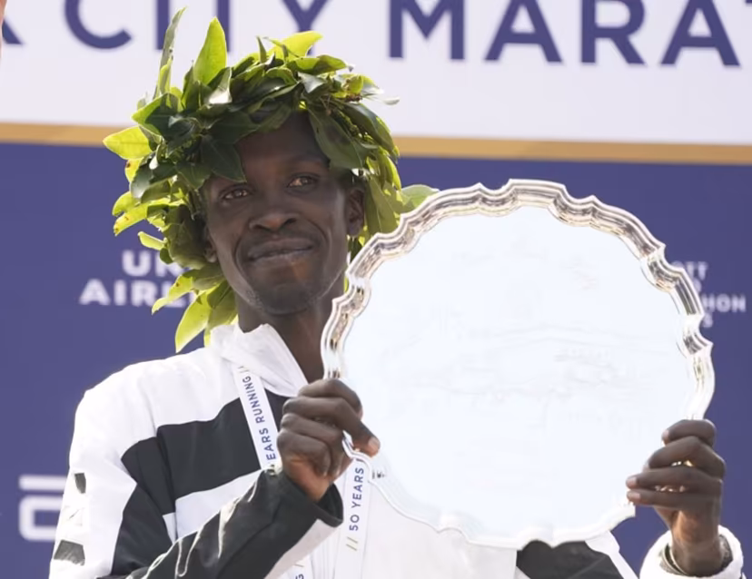 Men's division winner Albert Korir Kenya poses on the podium after the 2021 TCS New York City Marathon in New York on November 7, 2021. After a forced break in 2020, the New York City Marathon is back on for its 50th edition, and with it the countless opportunities to run it for charity, an industry that has become a staple, and hopes to take off again after the pandemic. TIMOTHY A. CLARY / AFP