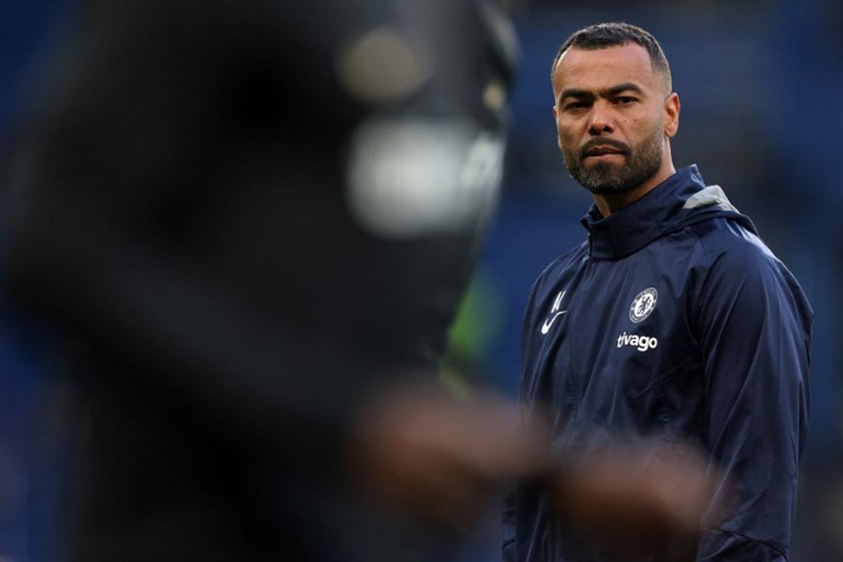 Chelsea assistant coach Ashley Cole watches players warm up ahead of the Champions League quarter-final second-leg football match between Chelsea and Real Madrid at Stamford Bridge in London on April 18, 2023. Adrian DENNIS / AFP