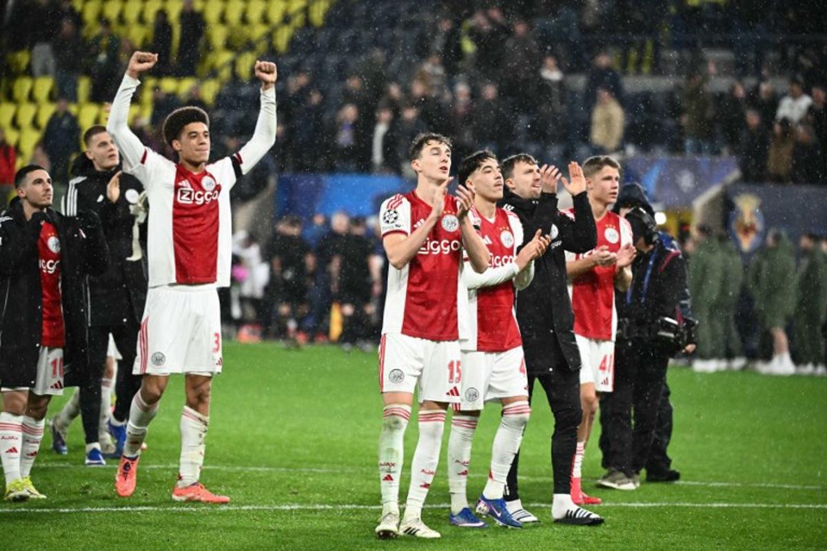 Ajax's Dutch defender #15 Youri Baas and teammates celebrate with supporters after winning the UEFA Champions League league phase day 7 football match between Villarreal CF and Ajax at La Ceramica Stadium in Vila-real on January 20, 2026. JOSE JORDAN / AFP