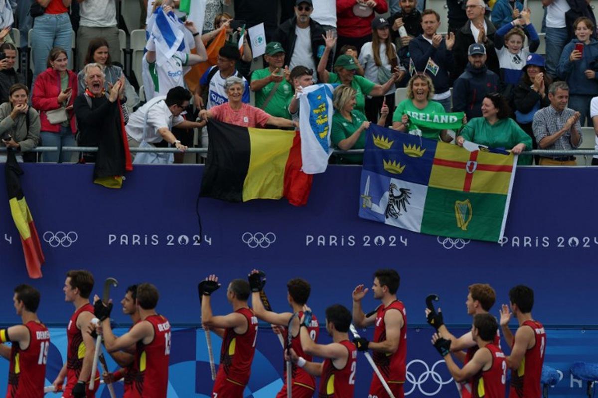 Belgium's players greet the fans after the men's pool B field hockey match between Belgium and Ireland during the Paris 2024 Olympic Games at the Yves-du-Manoir Stadium in Colombes on July 27, 2024. Ahmad GHARABLI / AFP