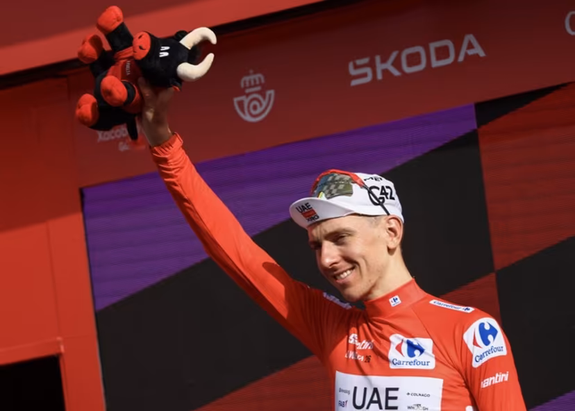 Overall race leader UAE Team Emirates - XRG team's Slovenian rider Tadej Pogacar celebrates on the podium the fifth stage of the Vuelta a Espana 2026, a 173,4 km race between Falset and Roquetes on August 26, 2026. Josep LAGO / AFP