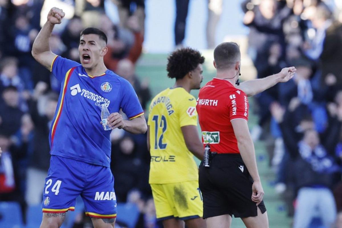Getafe's Argentine defender #24 Zaid Romero Player celebrates as referee awards penalty against Villarrea during the Spanish league football match between Getafe CF and Villarreal CF at Coliseum Alfonso Perez Stadium in Getafe on February 14, 2026. Oscar DEL POZO / AFP